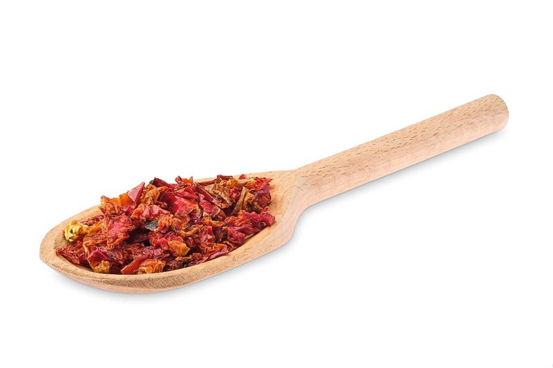 Wooden spoon with pepper isolated on white