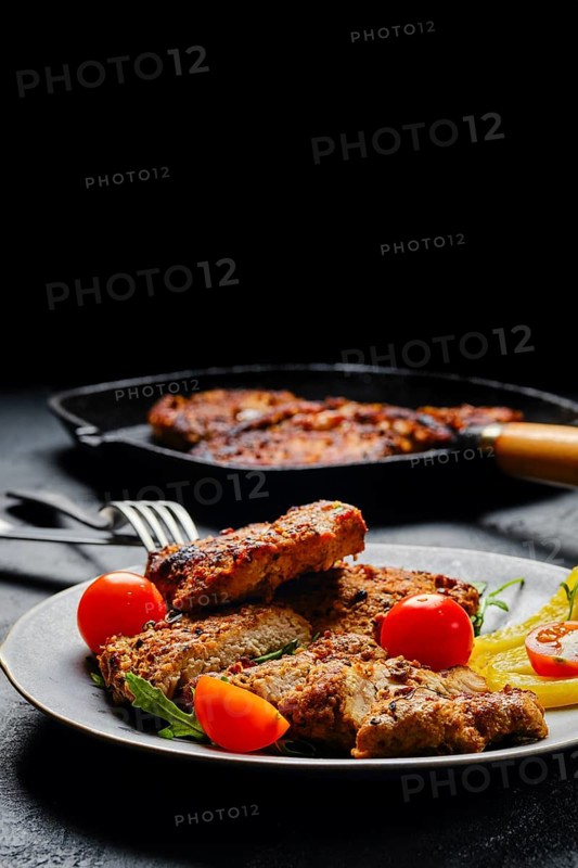Pork chop fillet baked in oven with seasoning and herbs