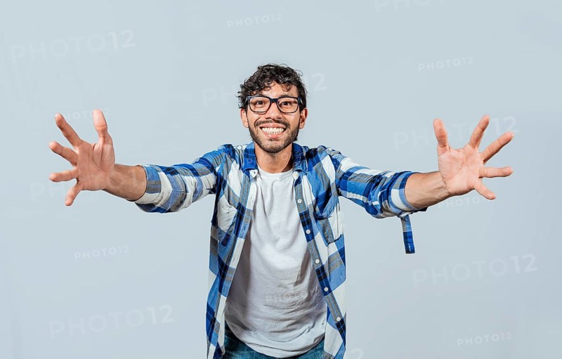 Man welcoming with open arms isolated. Friendly person welcoming. Generous young man with open arms isolated