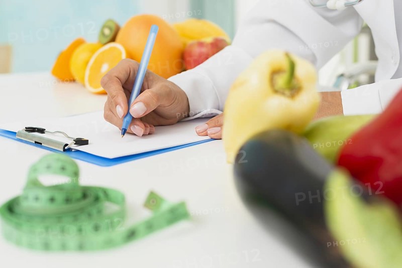 Close up nutritionist writing prescription