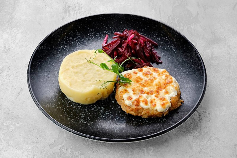 Kiev citlet with mashed potato and pickled beetroot on a plate