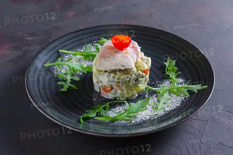 Olivier salad with slices of turkey