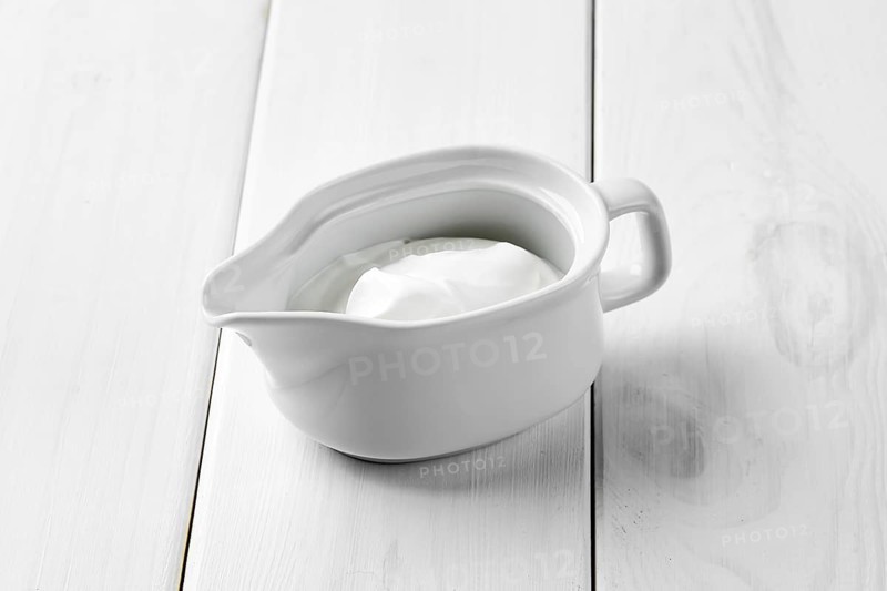 Sour cream in ceramic gravy boat