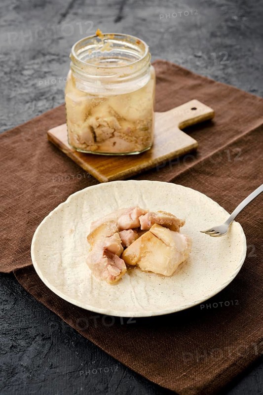 Canned cod liver in glass pot on the table