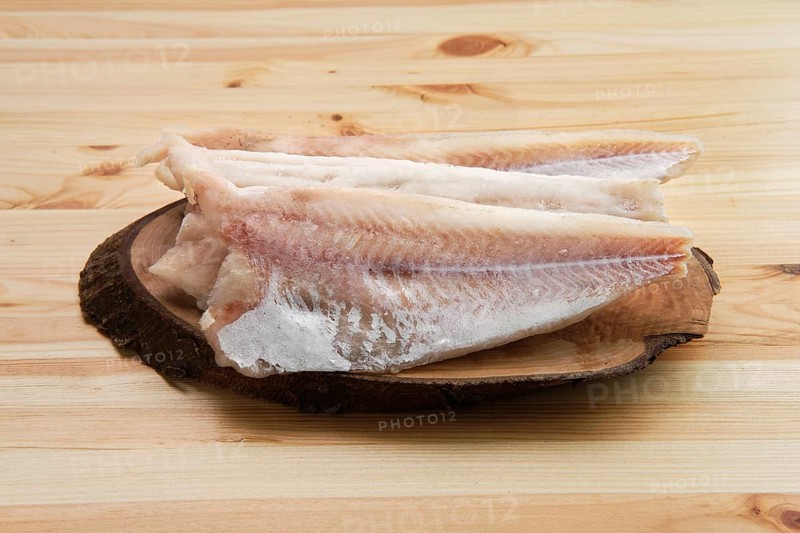 Frozen fillet of pangasius on wooden table