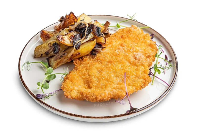 Tasty schnitzel in breading with fried potato