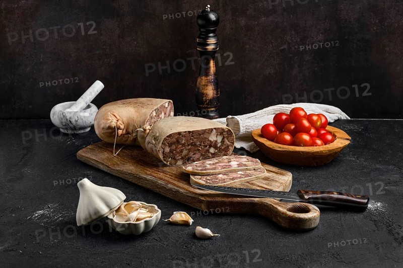 Boiled pork meat roll on wooden cutting board