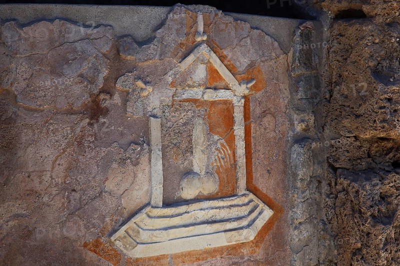 Stone relief of a penis as a reference to the brothel