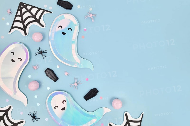 Cute pastel colored Halloween party flat lay with ghost shaped plates
