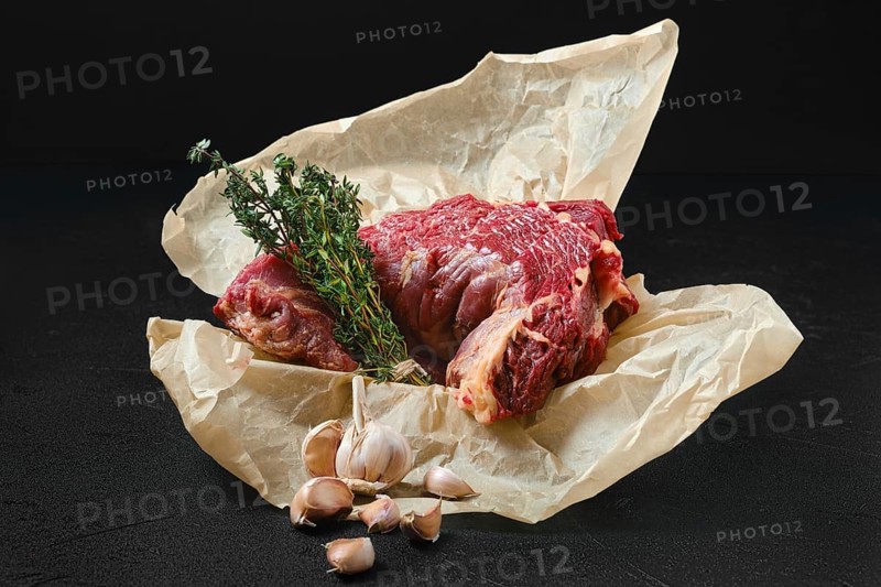 Raw beef neck with garlic packed in wrapping paper