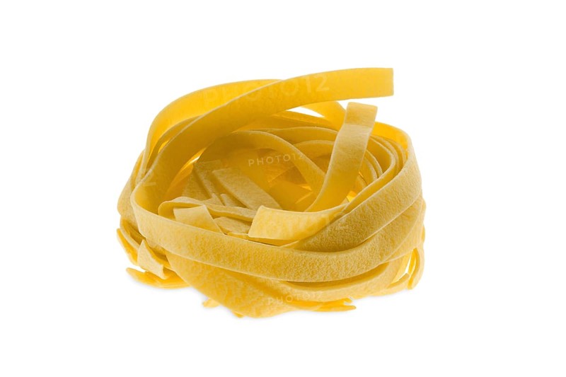 Nest noodles isolated on white background. Italian tagliatelle with egg