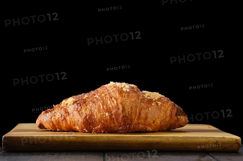 Classic croissant on wooden serving board