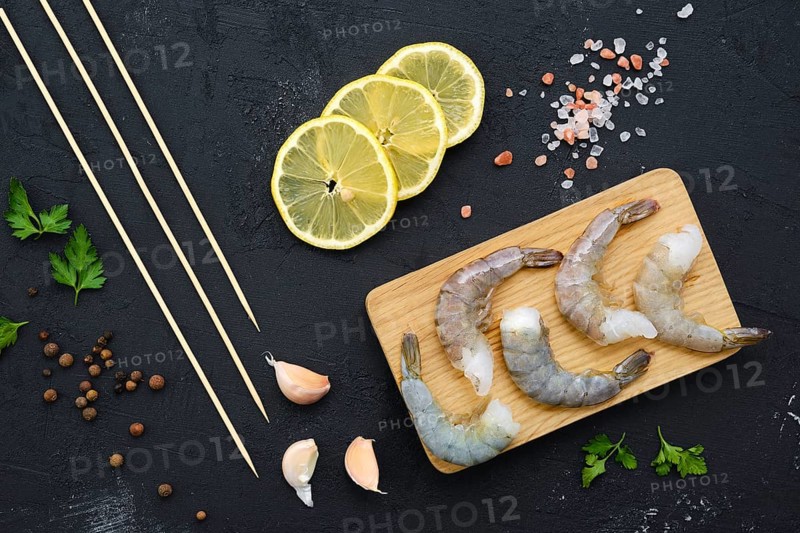Overhead composition with fresh raw prawn with spice and herbs