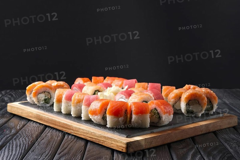 Big set of rolls served on stone plate. Layout for menu
