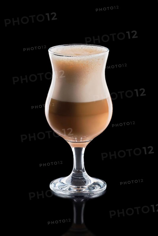 Cup of layered caramel latte isolated on black background.