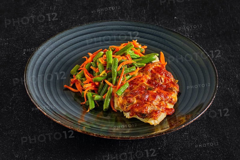 Fried fillet of white fish with cheese topping served with green bean and spicy carrot