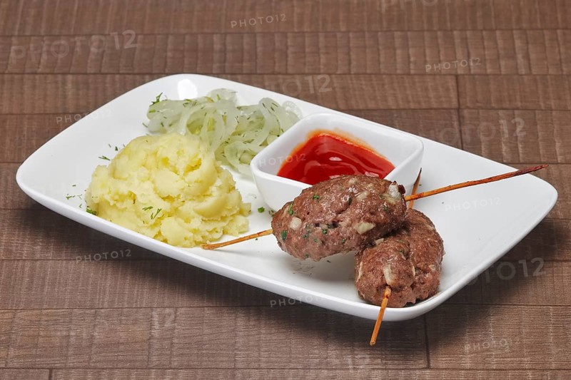 Lula kebab with mashed potato and sour onion