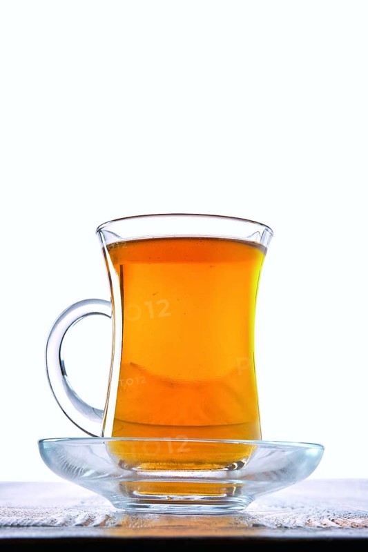 Low angle photo of cup with hot tea with copy space on white background