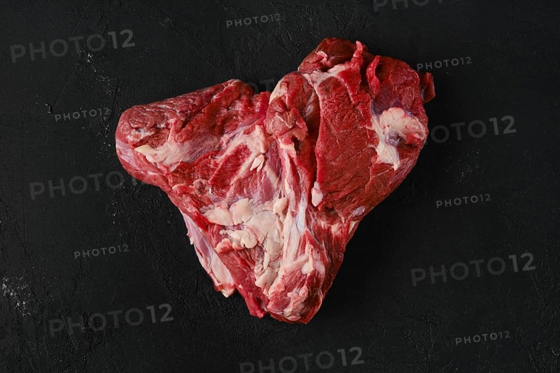 Raw beef top round roast on dark background