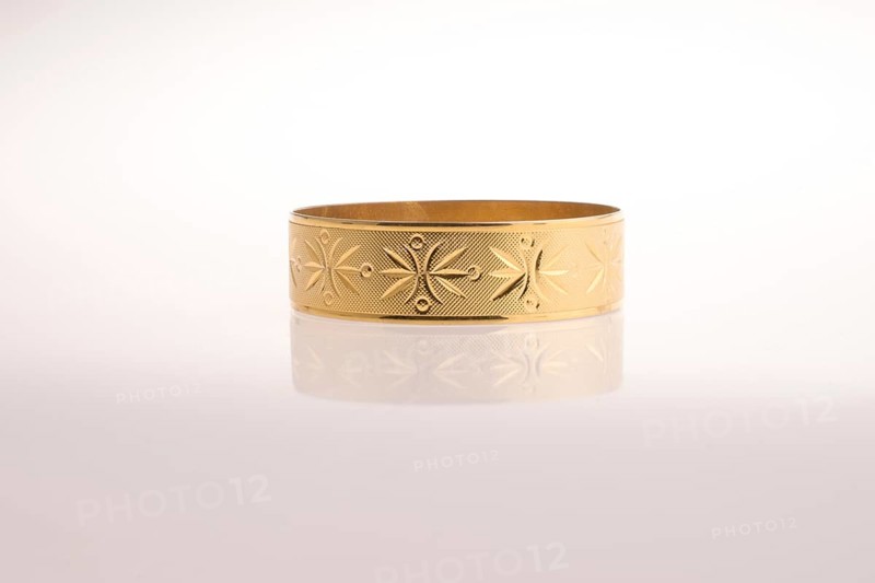 Golden bracelet on a white background
