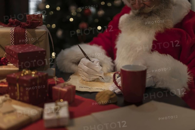 Close up santa claus writing letter