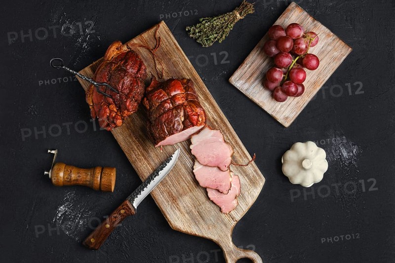 Air dried pork ham on wooden cutting board