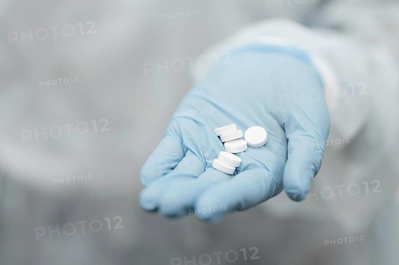 Close up hand holding pills