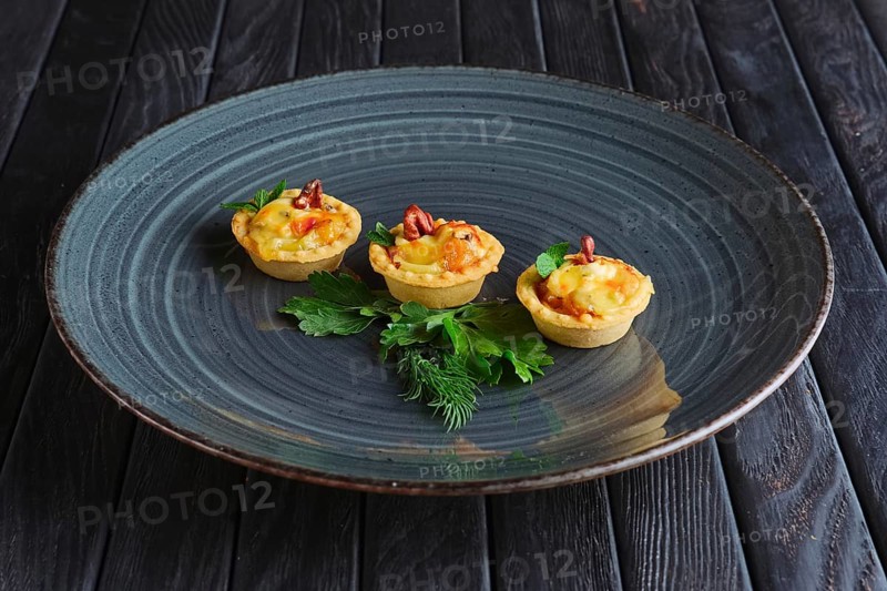 Appetizer for reception. Tartlet with bacon