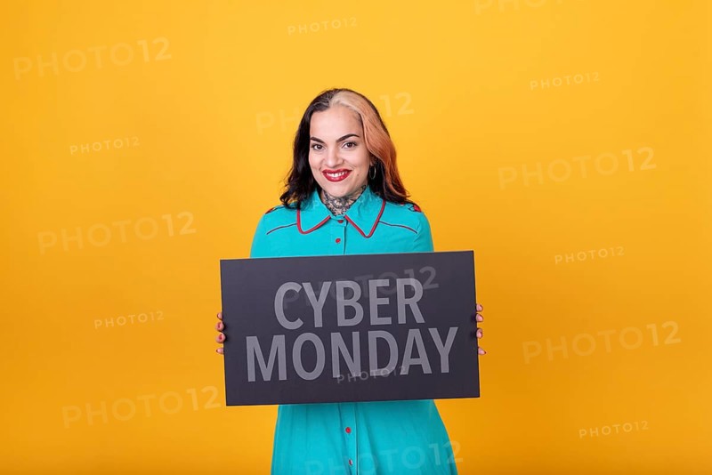 Beautiful woman holding a Cyber Monday sign. Commercial concept. Commerce