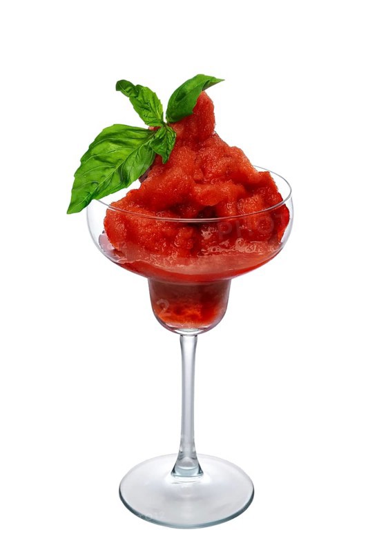 Watermelon smoothie in wide glass decorated with spinach leaves isolated on white