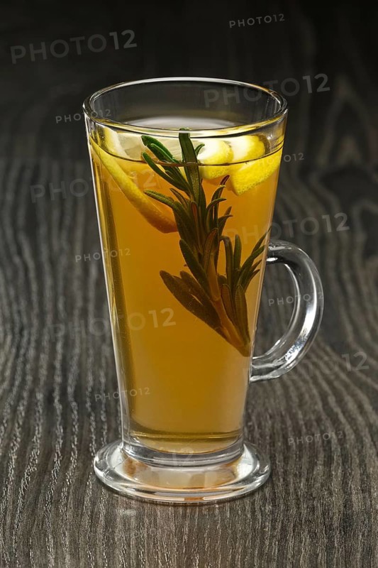 Glass of hot fruit tea on wooden table
