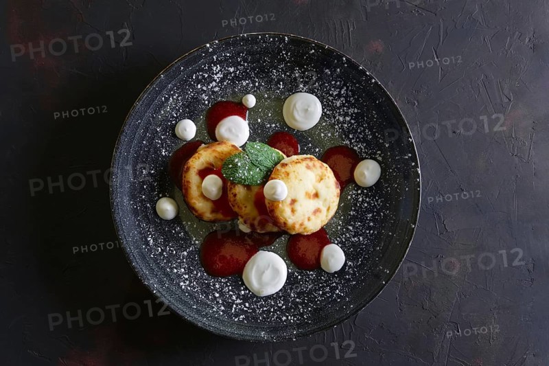 Cheese pancakes with sour cream and strawberry jam