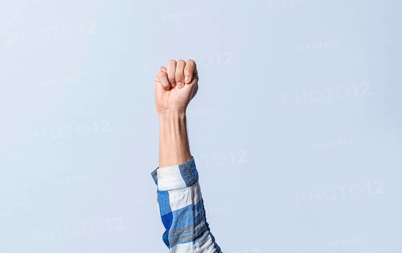 Hand gesturing the letter M in sign language on an isolated background. Man's hand gesturing the letter M of the alphabet isolated. Letter M of the alphabet in sign language