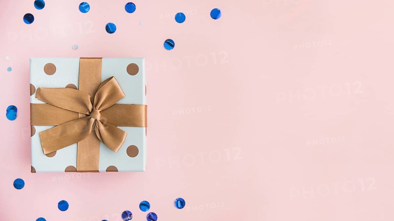 Wrapped present with brown bow and ribbon on pastel pink backdrop. Resolution and high quality beautiful photo