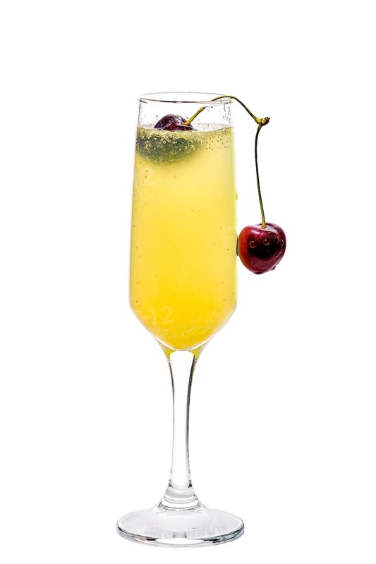 Mimosa cocktail decorated with cherry isolated on white background