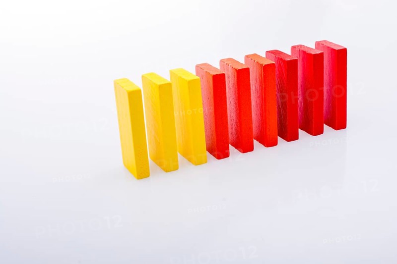 Colorful Domino Blocks in a line on a white background