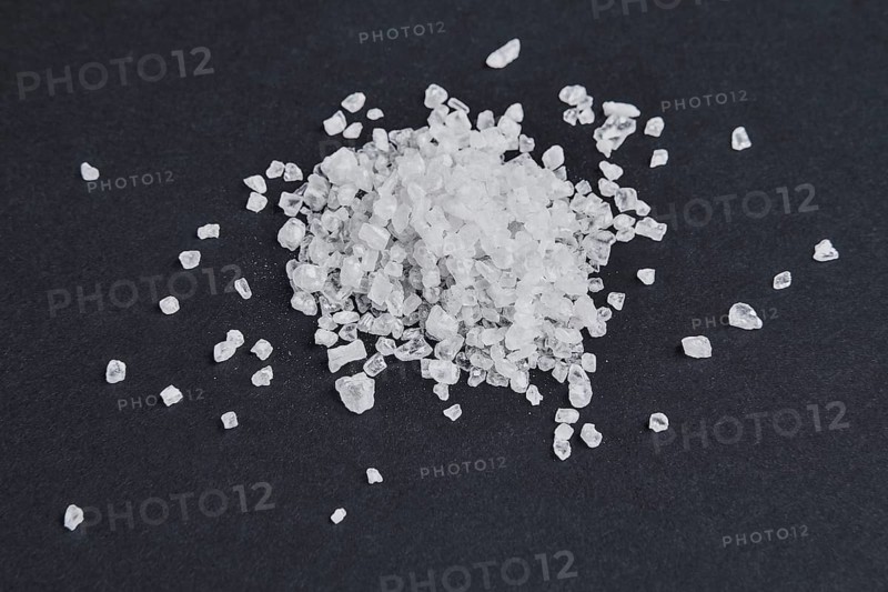 Sea salt on dark background. Top point of view