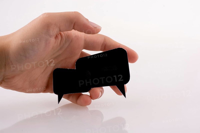 Hand holding dialogue boxes on a white background