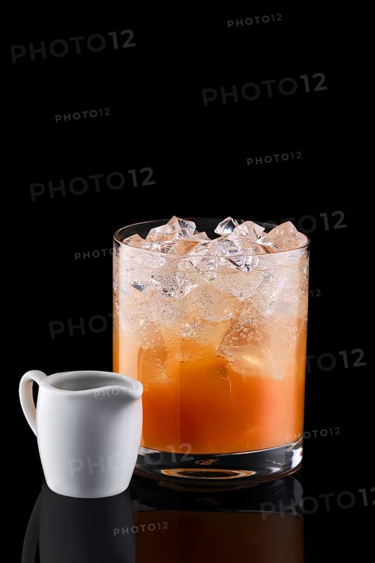 Espresso tonic with sea buckthorn syrup isolated on black background