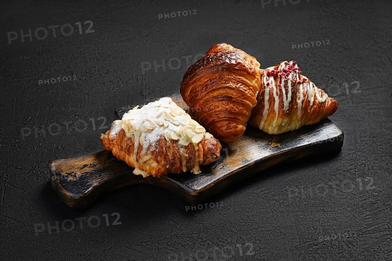 Assortment of crispy croissants on serving board