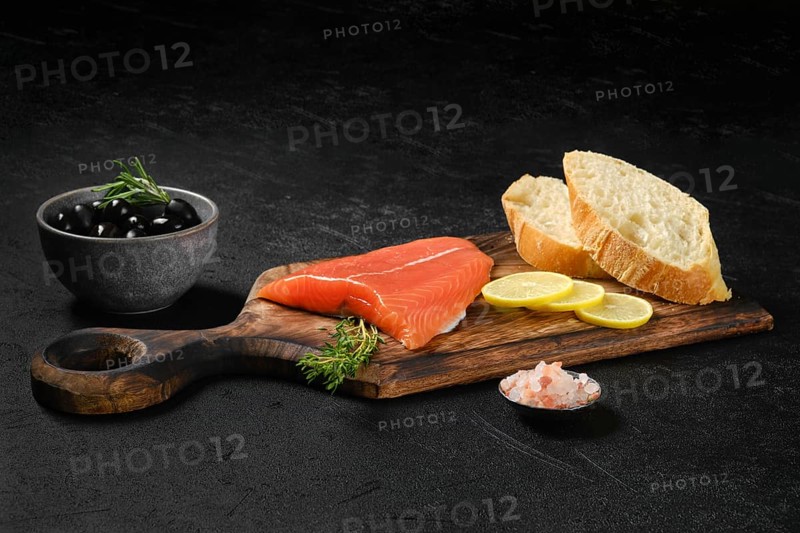 Piece of fresh salmon steak with ciabatta and spicy herb sauce