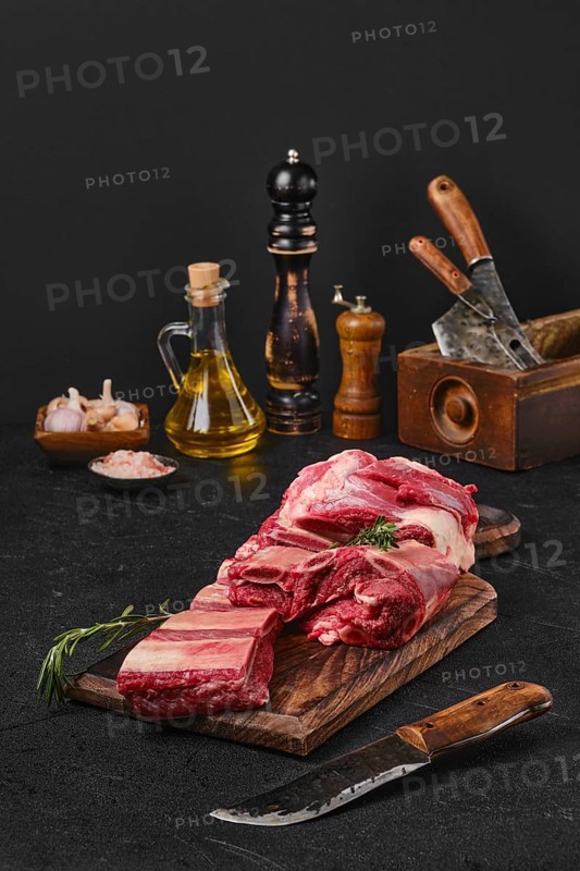 Raw fresh beef short rib stripes on wooden cutting board