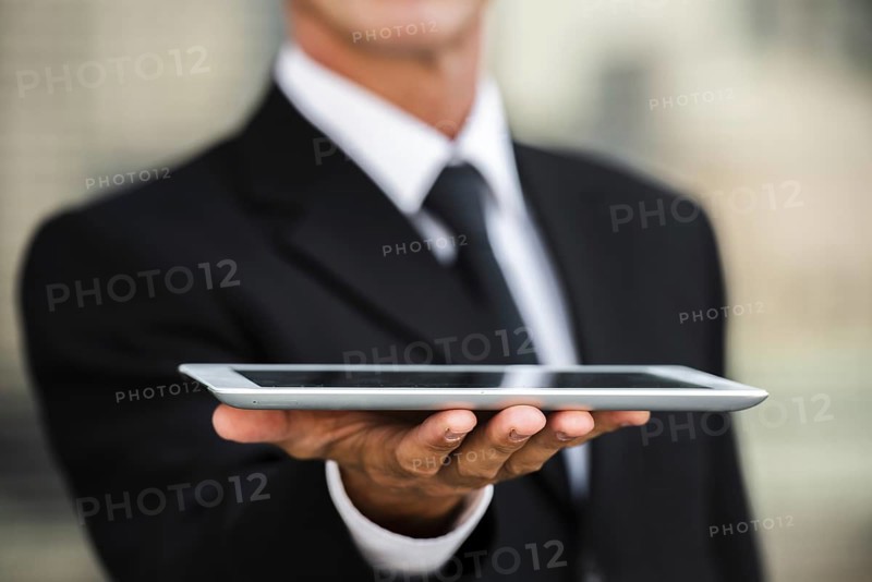 Close up businessman holding tablet hand