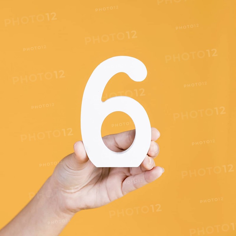 Close up hand holding number 6