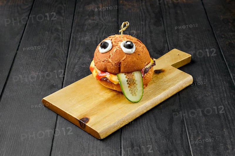 Hamburger with beef for children on wooden board