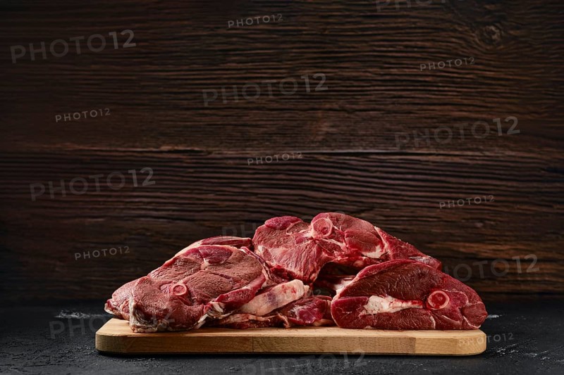 Assortment of raw fresh lamb meat on wooden tray