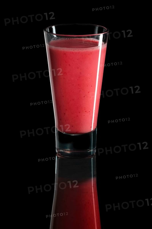 Glass of cherry and watermelon cocktail isolated on black