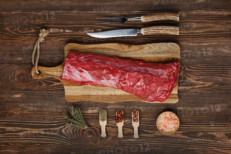 Overhead view of raw fresh beef tenderloin roast with spices