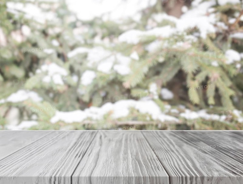 Empty wooden table front christmas tree with snow