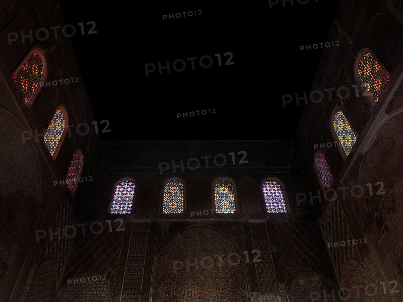 Colourful mosaic windows in the dark